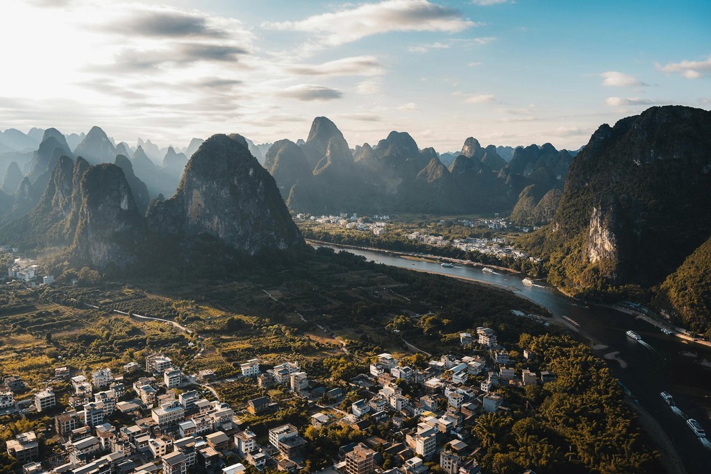 Karst mountain peaks rising above a river valley, representing destinations across Asia and Europe