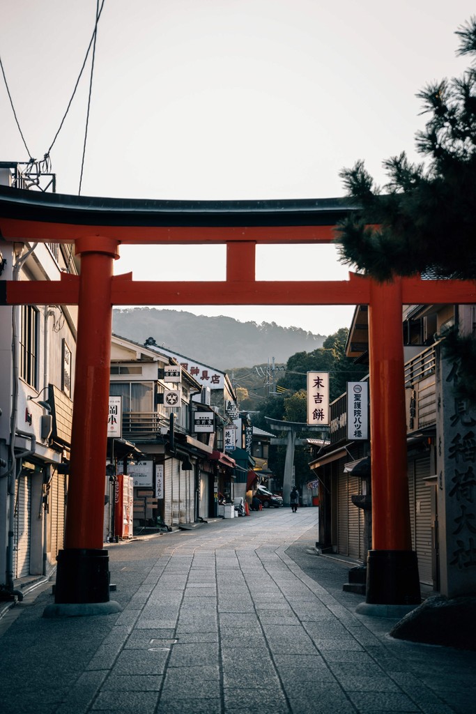 Ancient temple ruins with classical stone columns and arches in a historic city setting