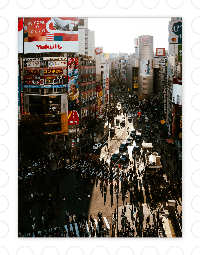 Aerial view of Shibuya Crossing in Tokyo framed within a stamp-style border